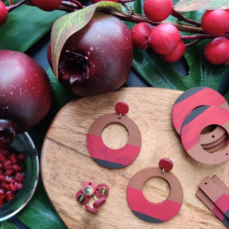 Handcrafted large, round, red, brown and dark brown color blocked neutral tone statement earrings by the brand SCOTCHBONNET.